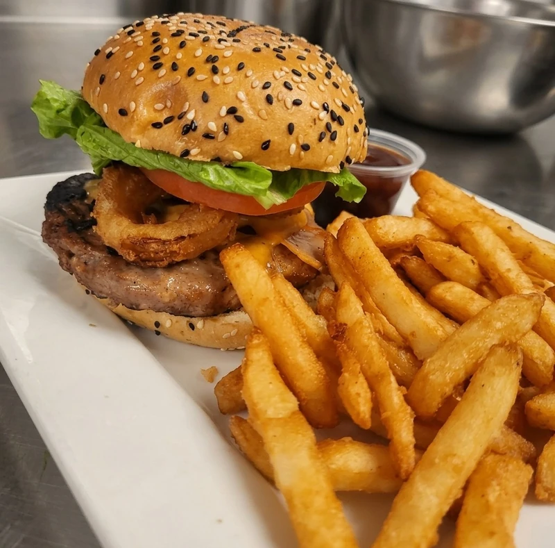 Cowboy Burger with bacon, cheddar and onion rings plus fries at Nick's Lounge in Bonnyville, AB